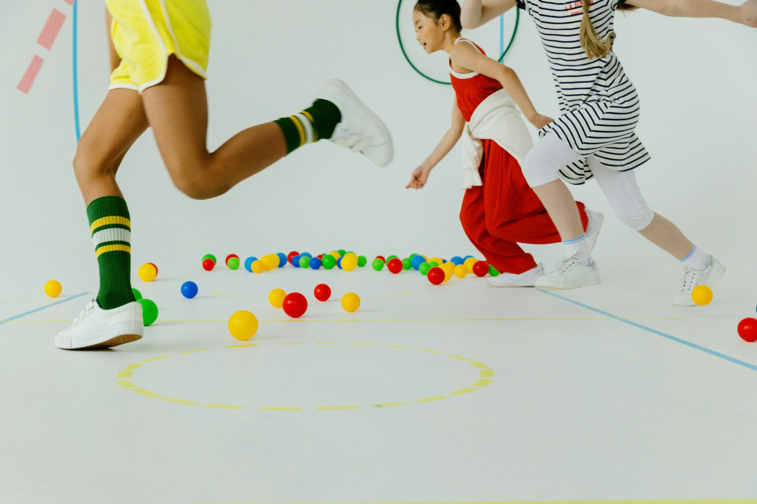 kids gym lesson with colorful balls